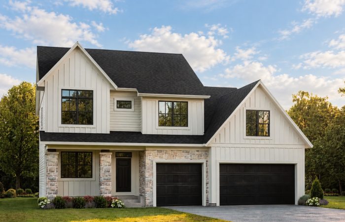 Modern two-story white house with black garage doors and large windows.
